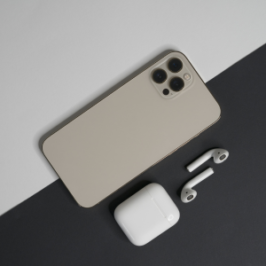 iPhone displaying ads with AirPods on the side, illustrating the impact of iOS privacy updates on advertising.